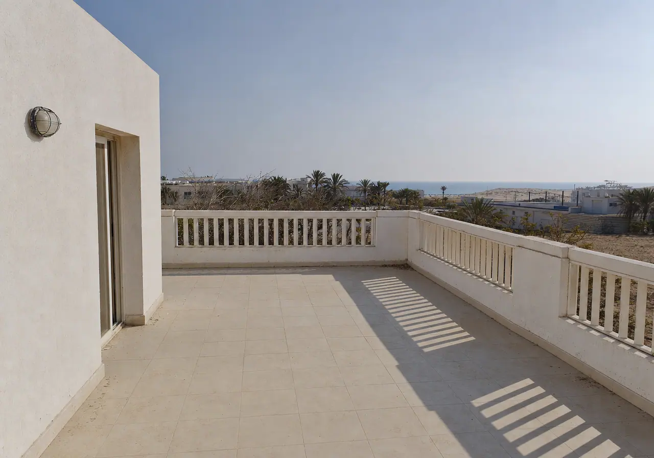 A bare whitewashed coastal chalet terrace before styling